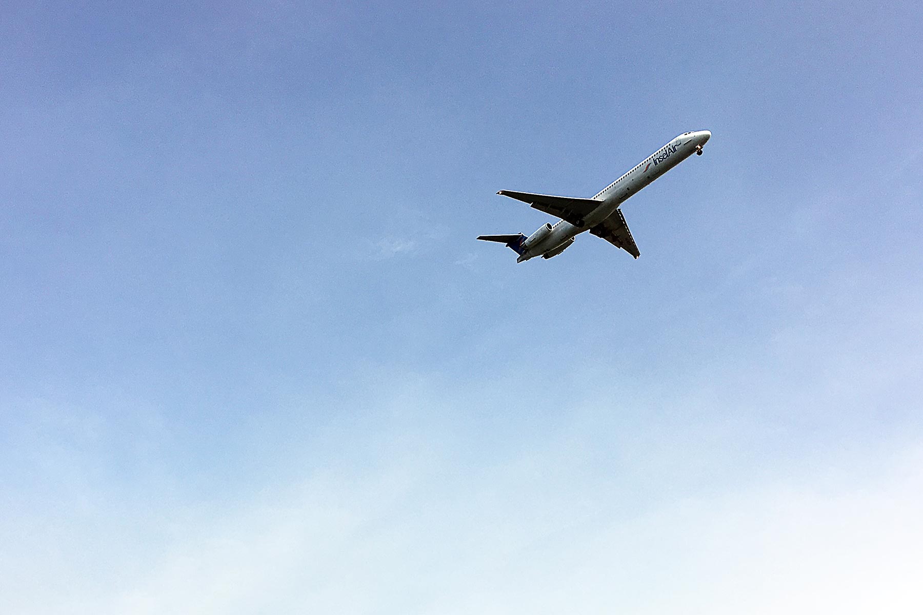 A plane flying in the blue sky