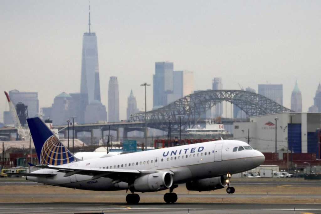 FILE PHOTO A United Airlines passenger jet takes off with New York City as a backdrop