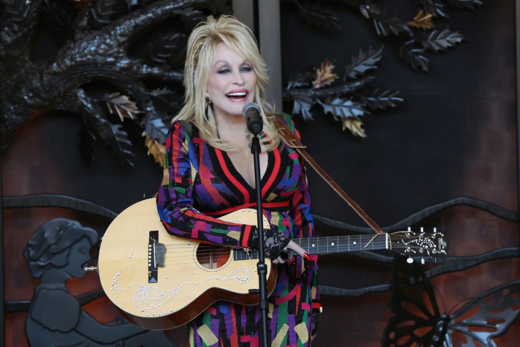 Dolly Parton performing at grand opening of Dollywood’s HeartSong Lodge & Resort which is one of Dolly Parton's hotels