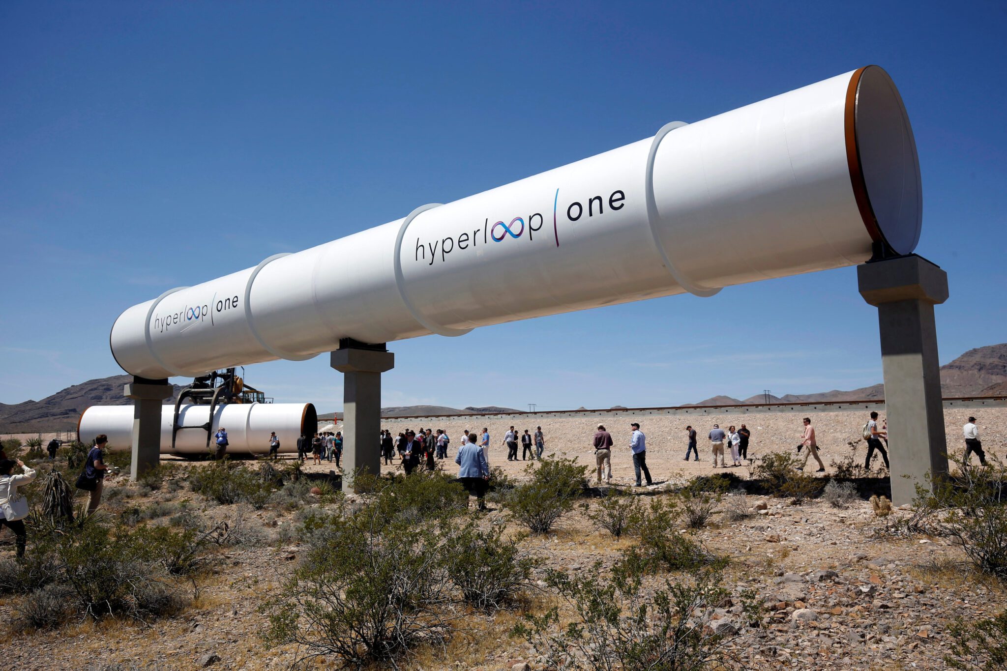 Journalists and guests look over tubes following a propulsion open air test at Hyper loop One in North Las Vegas. Source: Reuters