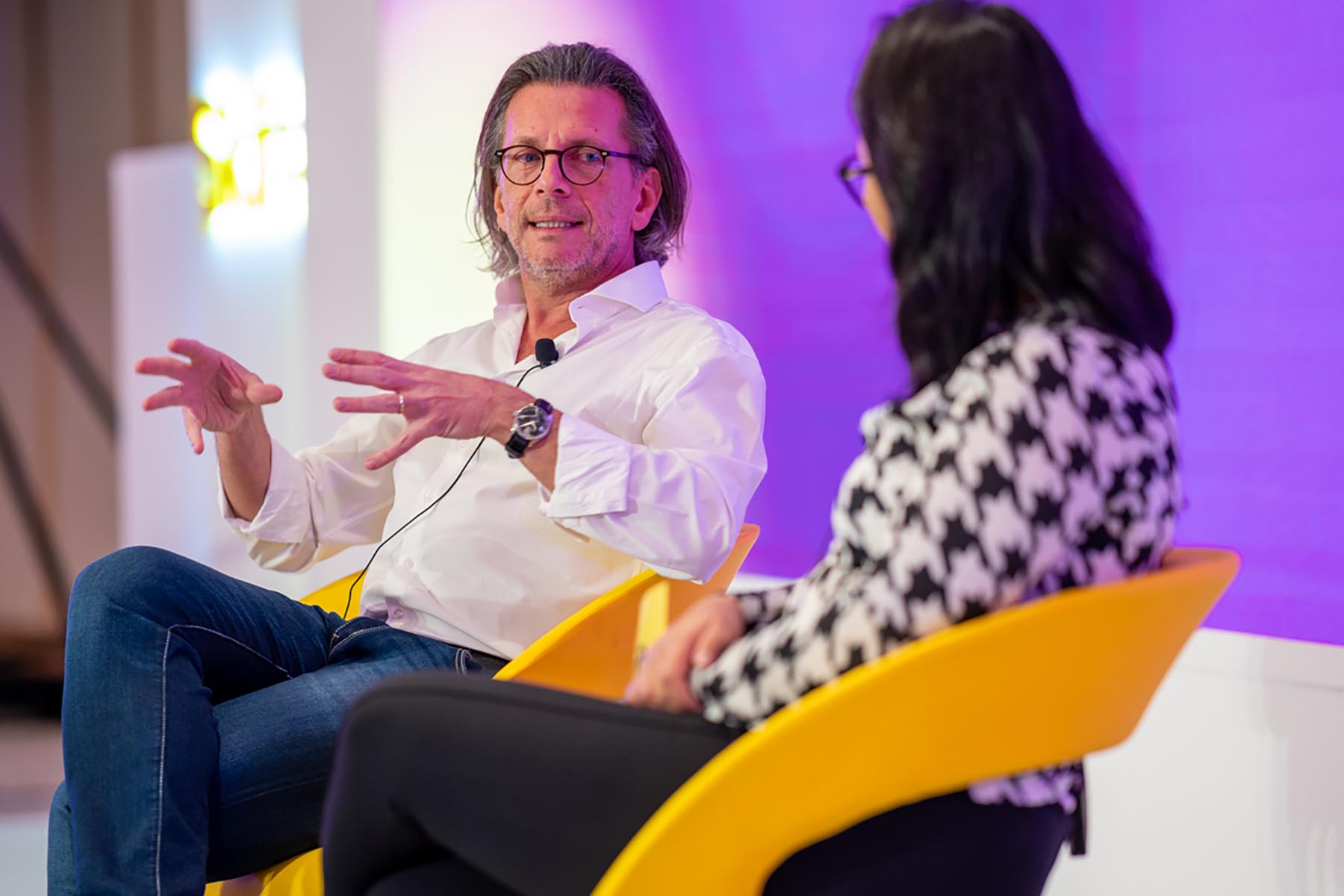 Two people on stage in a panel discussion