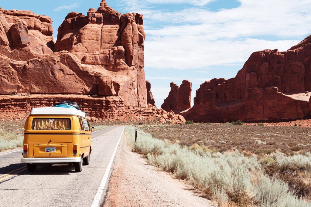 A yellow fan driving in the desert.