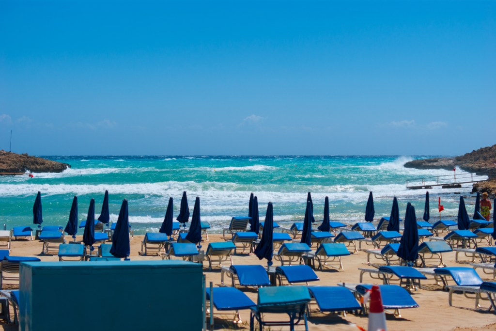 Blue sunbeds on a pretty beach