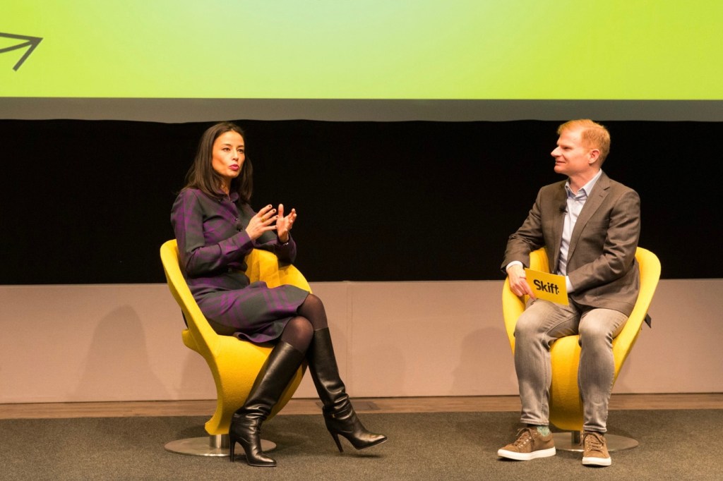 A woman and man speaking on stage