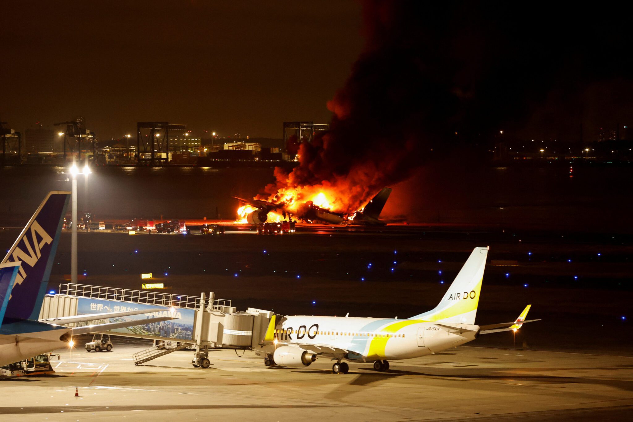 A Japan Airlines plane burns on the runway at Tokyo's Haneda Airport.