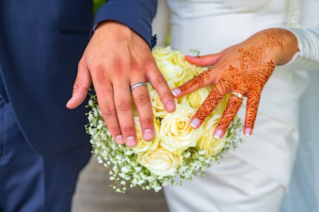 Close-up-of-couple-showing-rings-on-hands