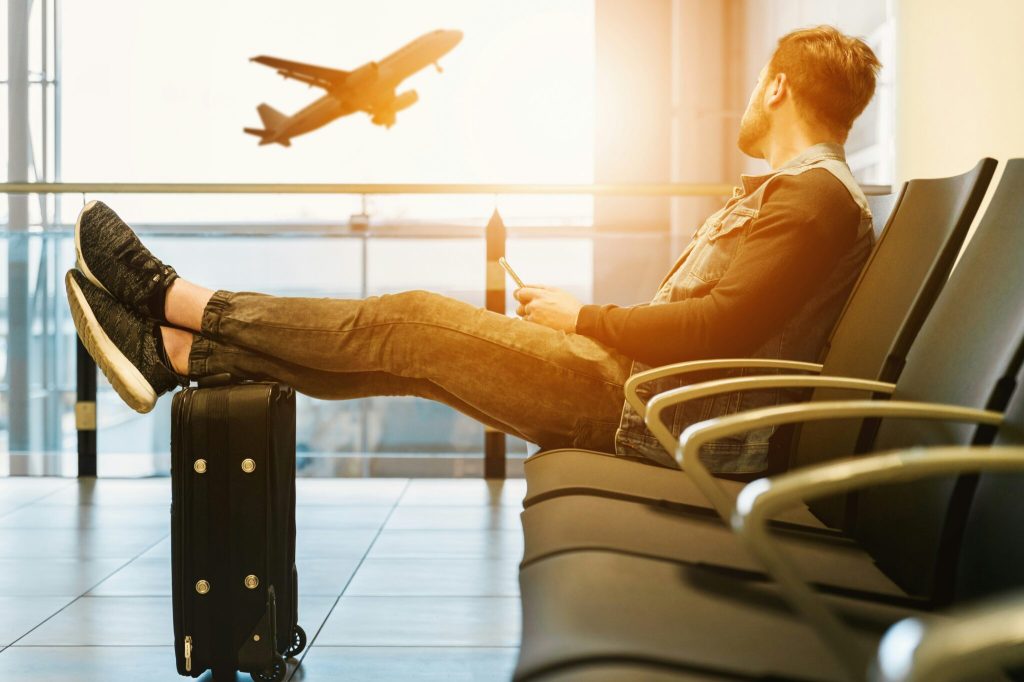 man at airport waits for flight