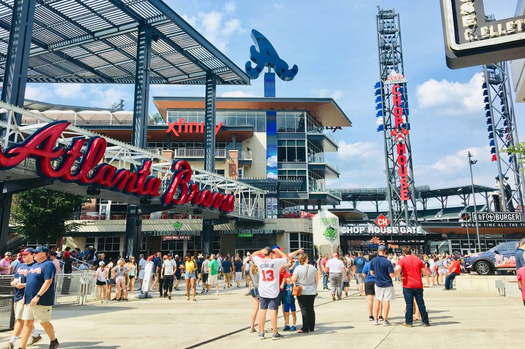 Exterior of a stadium with fans and concessions.