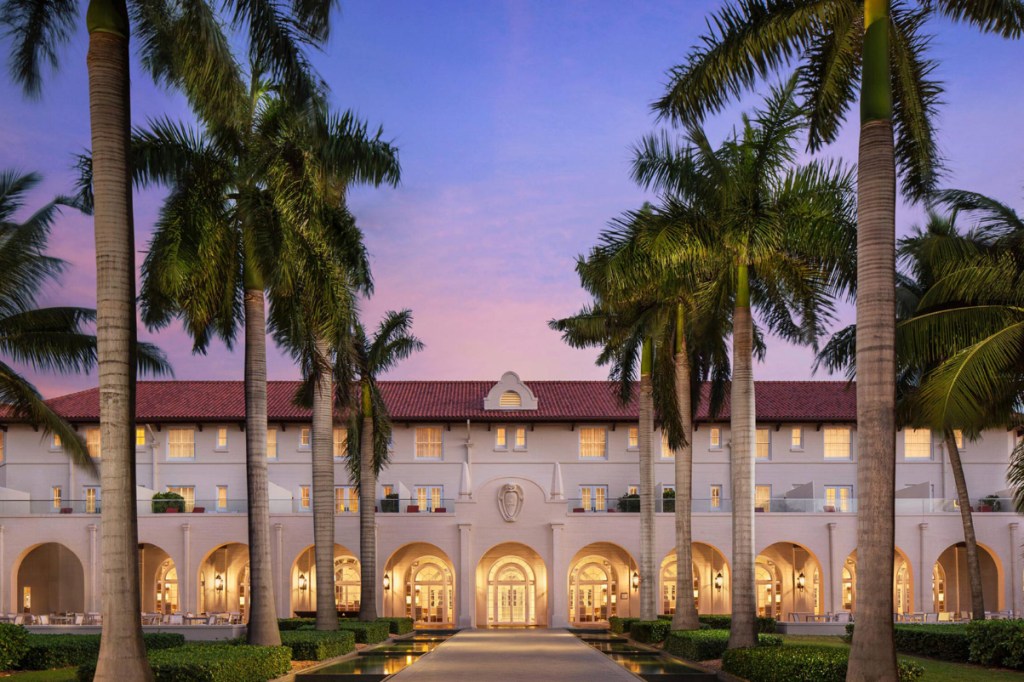 a view of the entrance with palm trees of a resort hotel in the florida keys