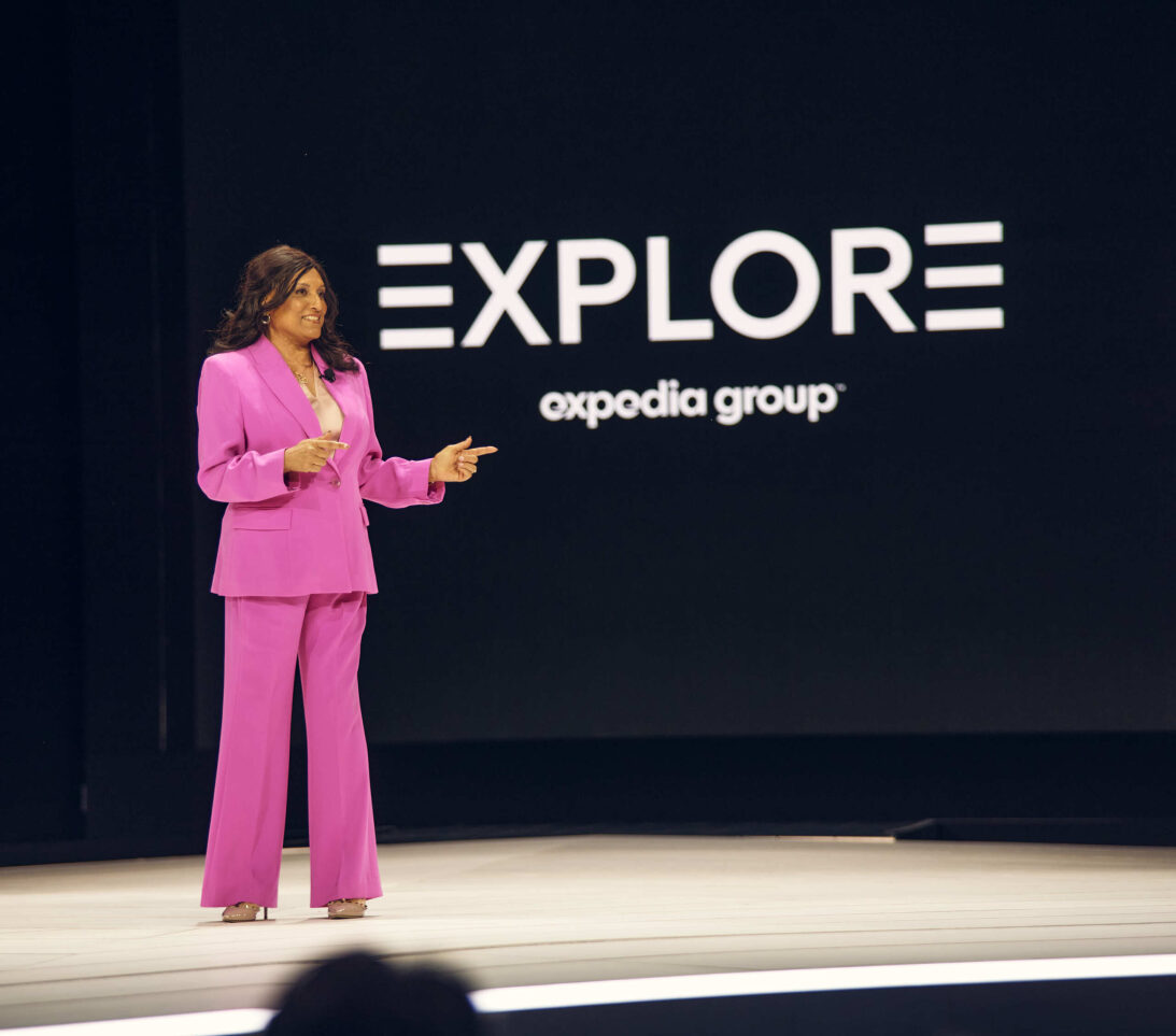 A woman speaking on stage to aa conference.