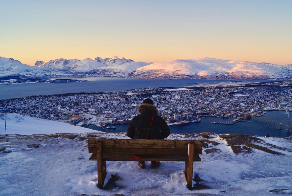 A man overlooking Tromso, Norway in the winter.