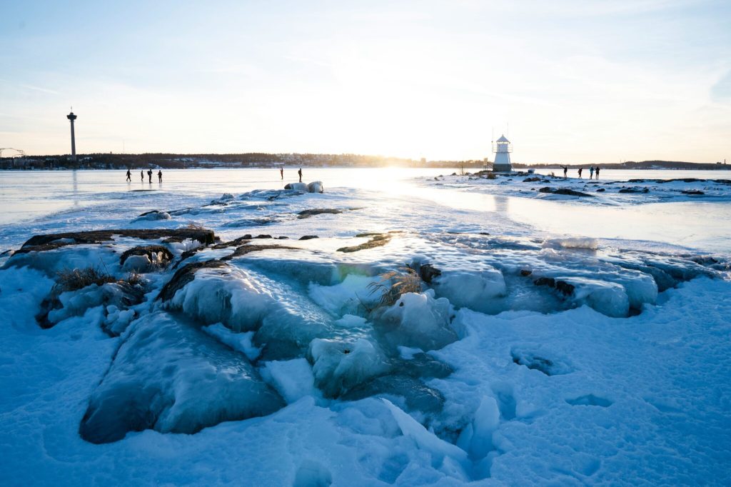 People walking on a frozen lake near the city of Tampere