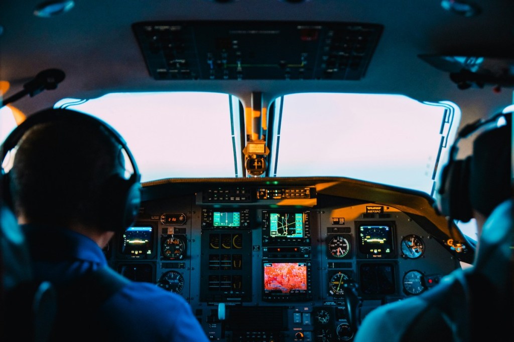 Two pilots in the cockpit of a plane.