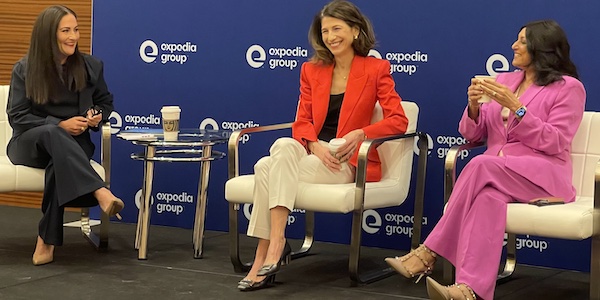 Three women leaders sit on stage at an Expedia conference in Las Vegas.