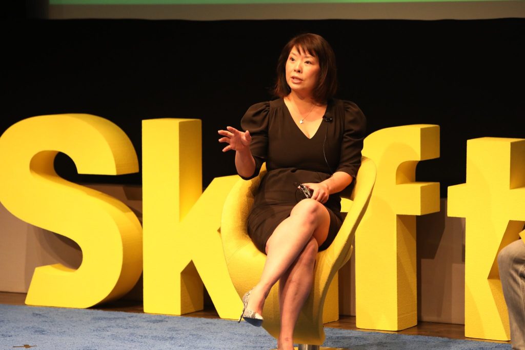 Jennifer Hsieh sitting on stage at the Skift Short-Term Rental summit