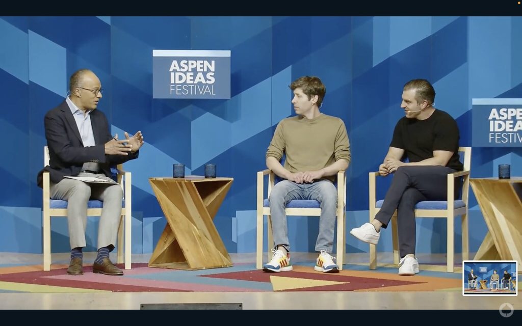 Three people on a stage discussing generative Artificial Intelligence.