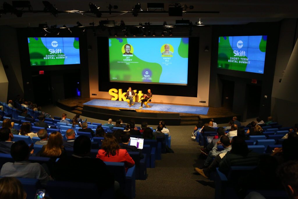 View of a crowd watching two people speak on stage