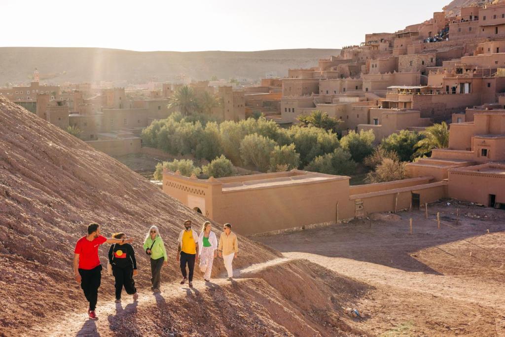 A tour of people hiking through Morocco's Ait Benhaddou