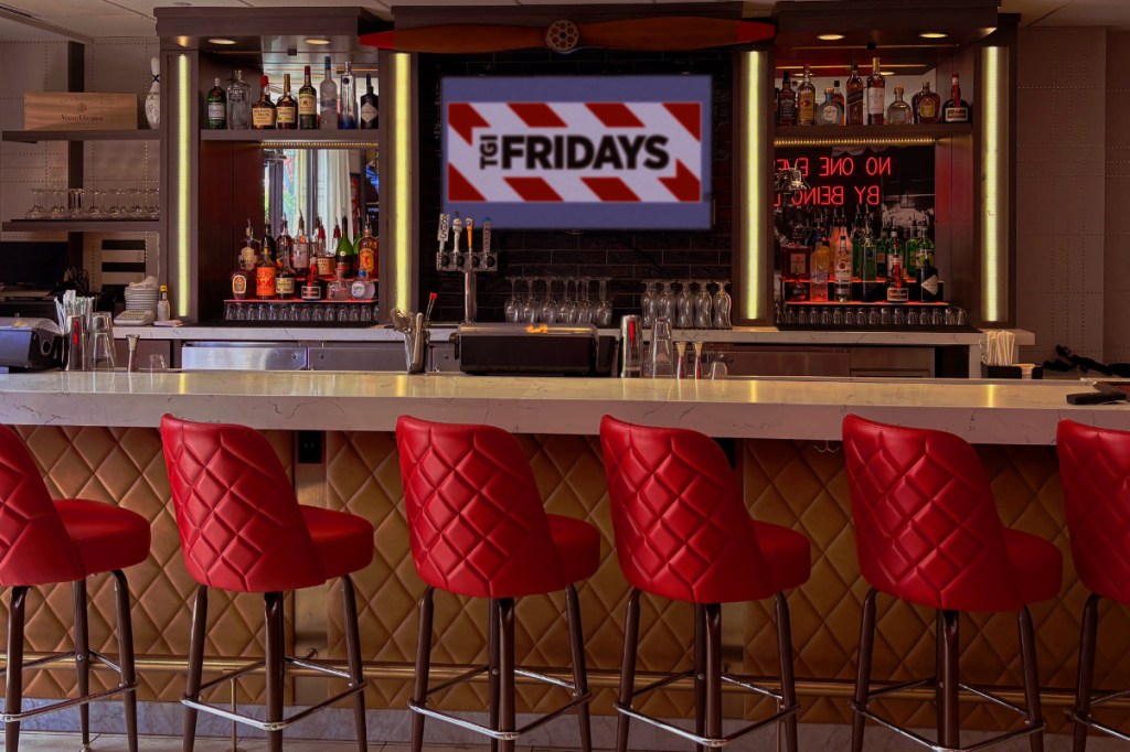 inside a TGI Fridays fast casual restaurant looking at the counter where there are stools for guests at a new restaurant inside a hotel in california