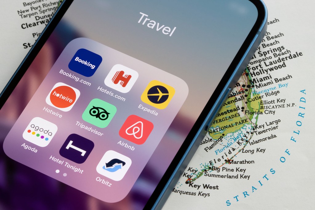 Multiple travel room booking apps on an iPhone screen.