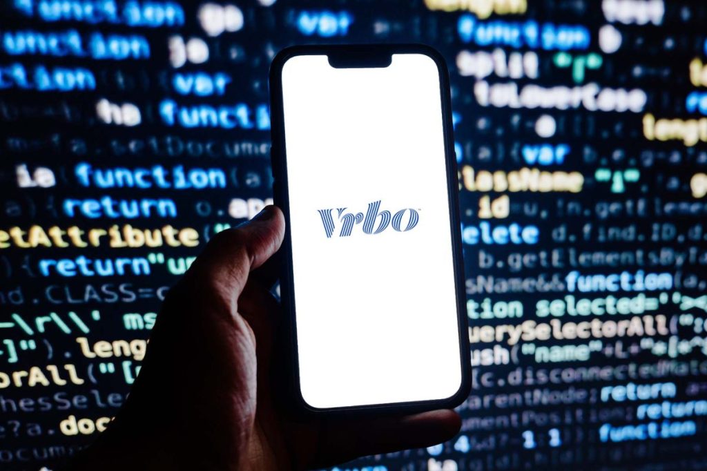 Vrbo logo on a smartphone screen.