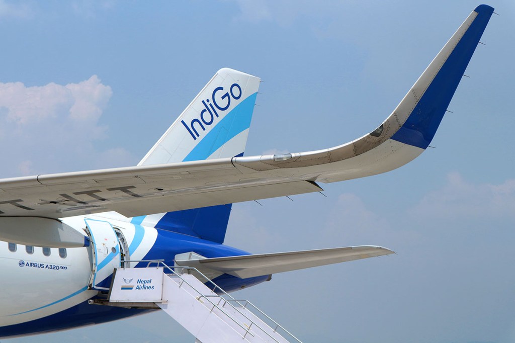 A movable staircase pulled up to the rear of an airplane