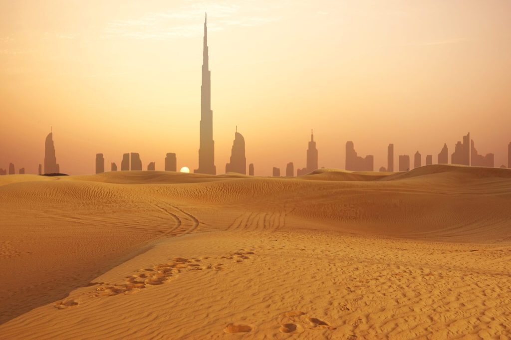 An image of Dubai with desert in the foreground.