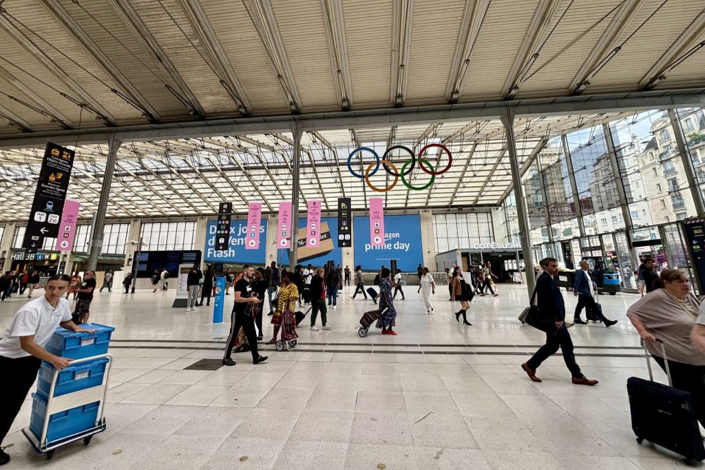 Interior of a train station with people walking back and forth