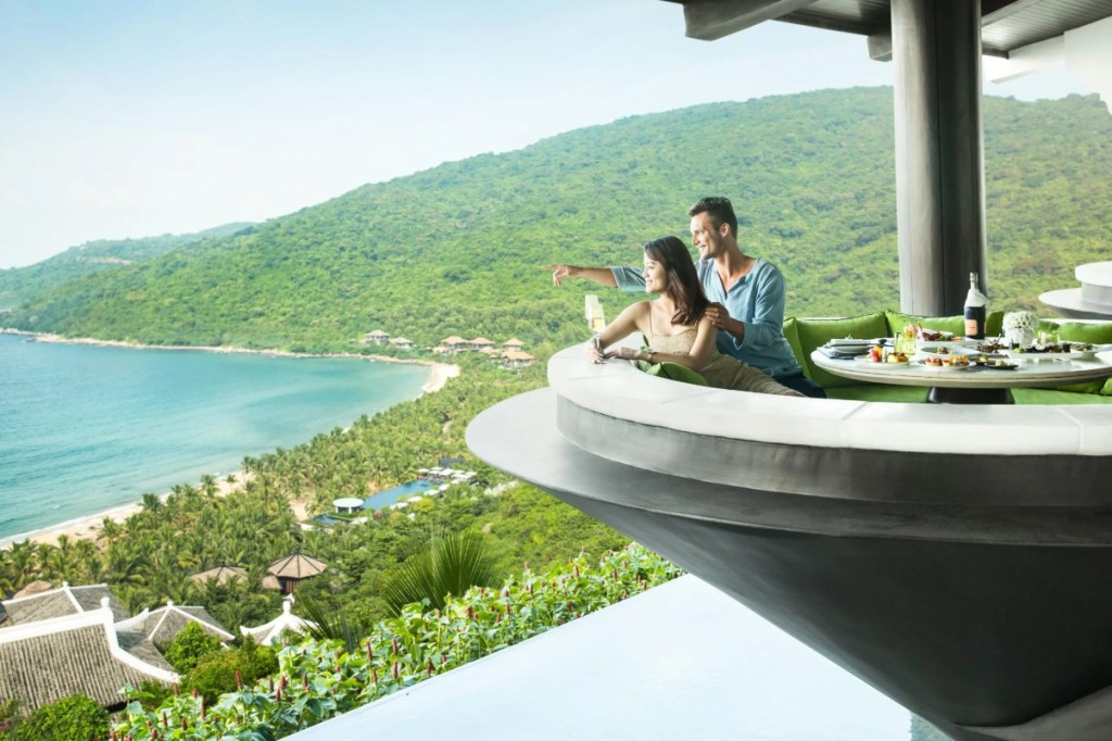 travelers on a modern balcony overlooking a resort area in China