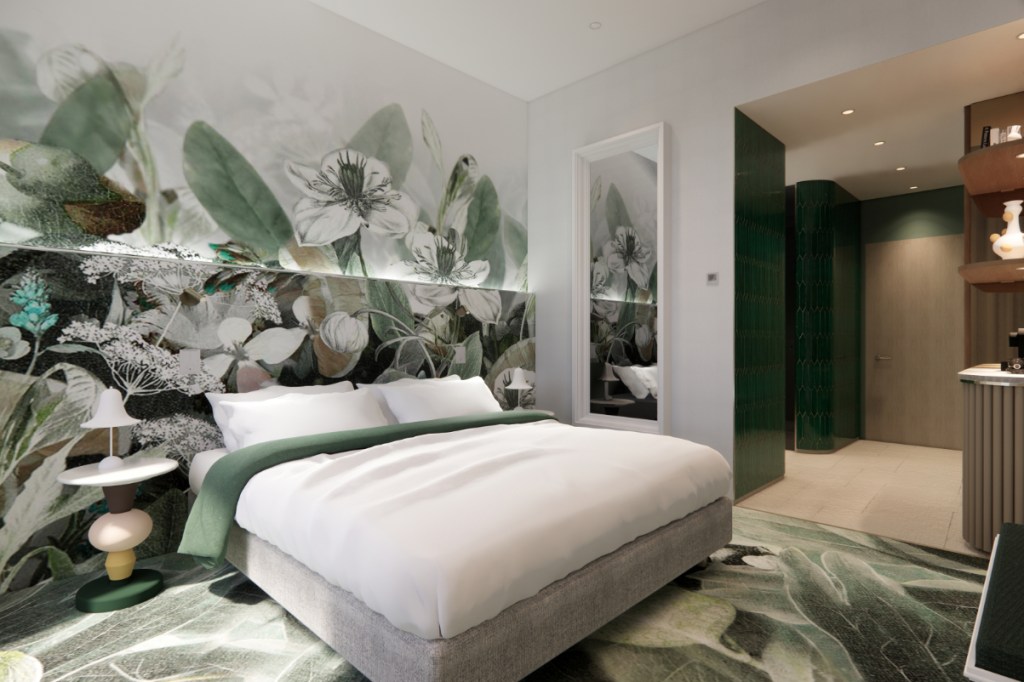 a guestroom at a boutique Kimpton hotel in Budapest with colorful wallpaper with a green enviornmental theme