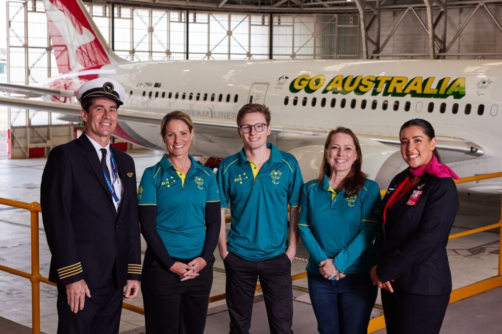 Qantas and Paris 2024 athletes in front of the specially designed plane