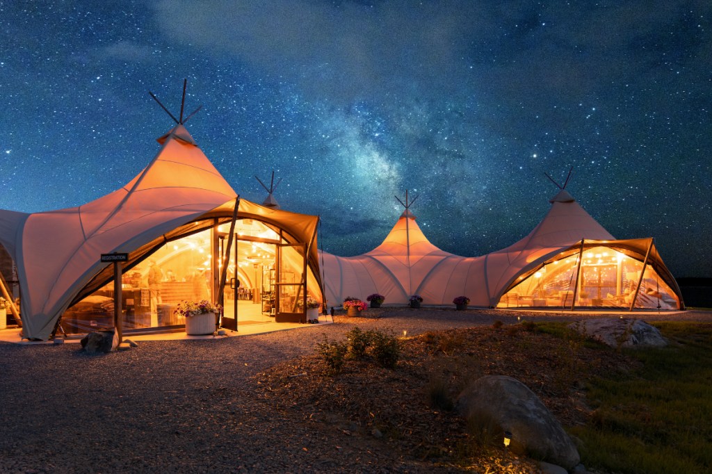 a view of a tented resort under a clear night sky