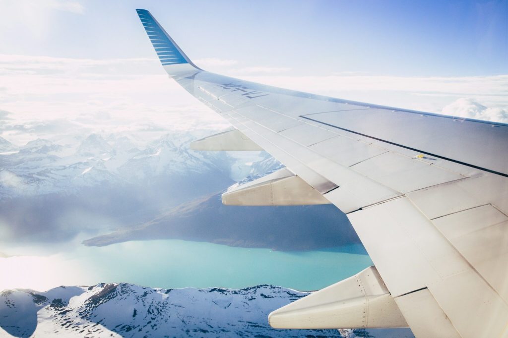 The view from an airplane window overlooking glaciers.