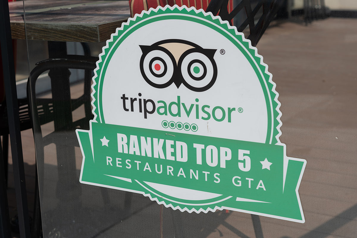 A Tripadvisor vinyl decal on a restaurant window.