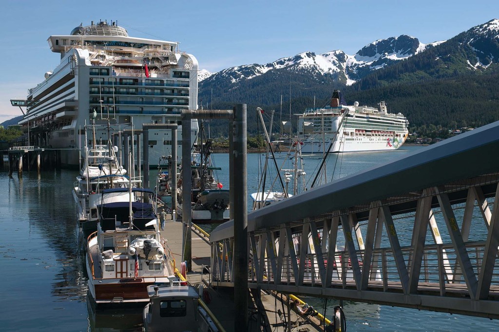 gangway and cruise ships dock in a harbor.