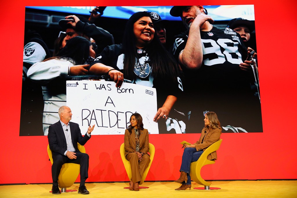 Three people in an interview session on stage.