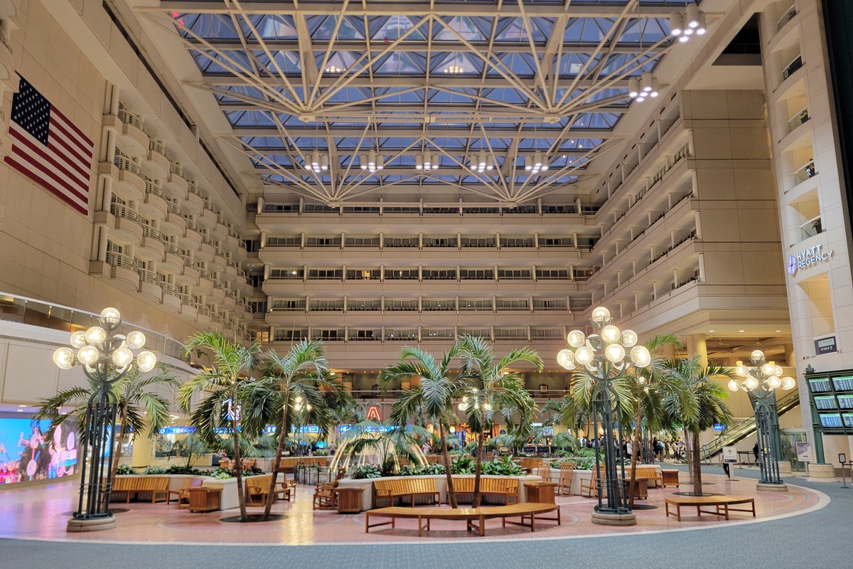 A multi-story interior courtyard with a glass ceiling