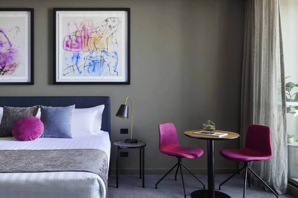 a hotel room with art on the walls