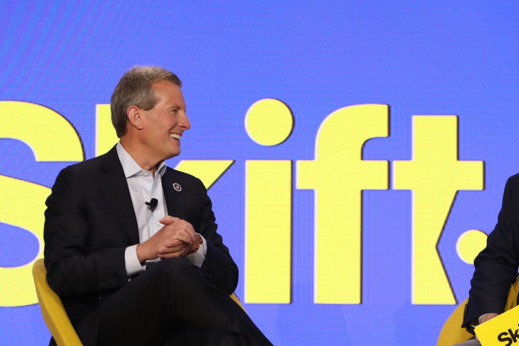 executive speaking onstage at skift global forum geoff ballotti ceo and president of wyndham hotels resorts skift global forum 2024