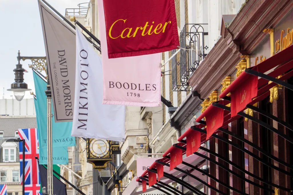 Flags waving from luxury shops on a London street