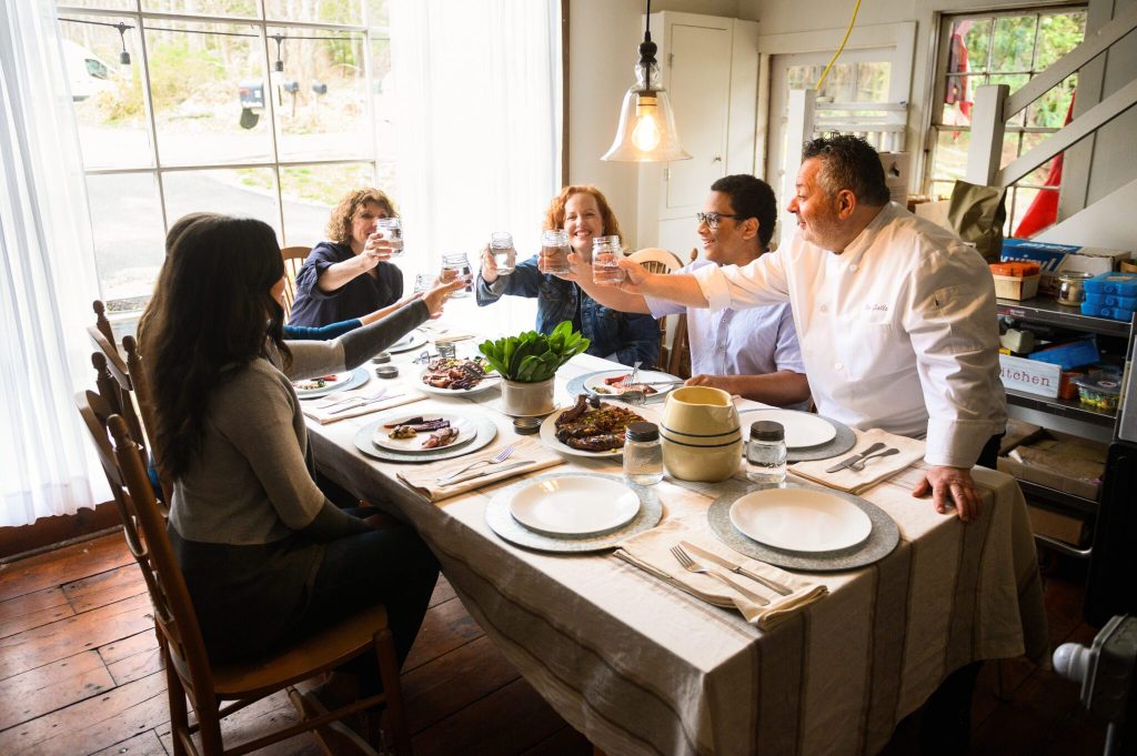 People sitting at a table taking a farm to table class.