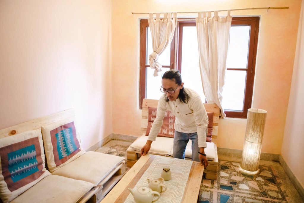 An Airbnb host arranging a table in a home.