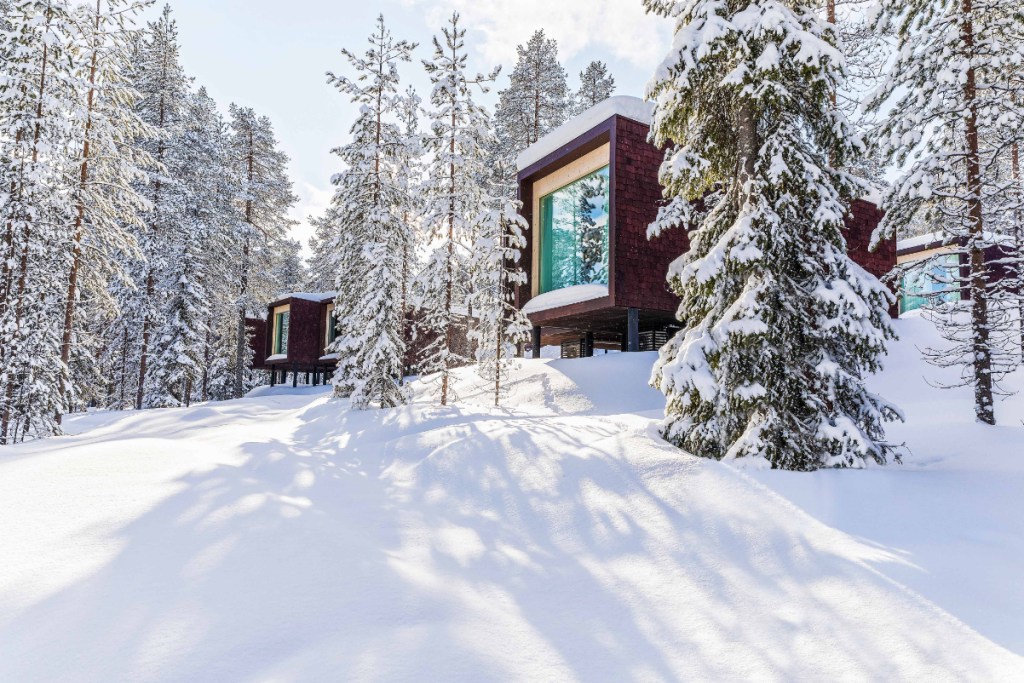 a strikingly designed hotel in the snow in Finland, exterior view