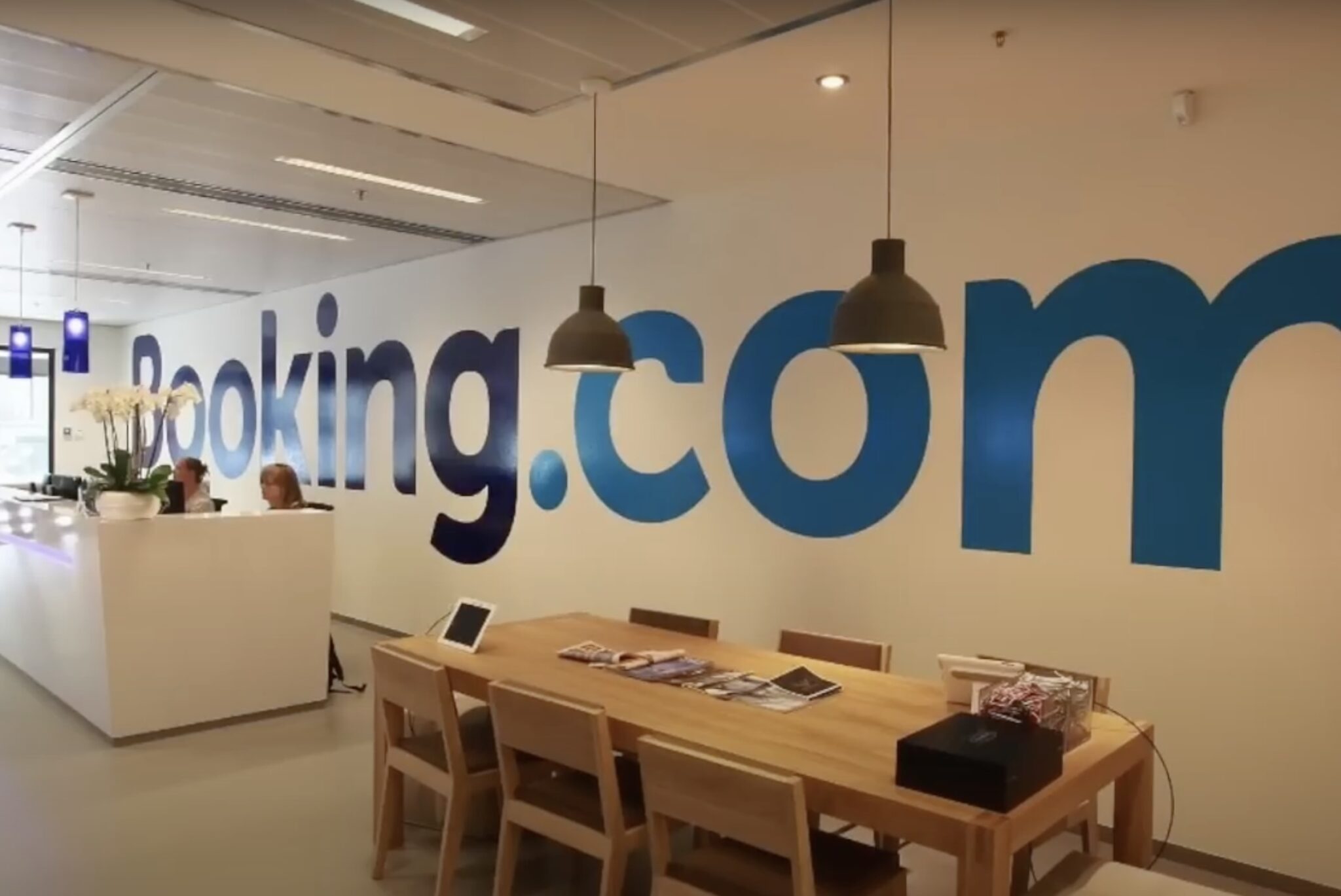 A Booking.com logo on a wall in its office.