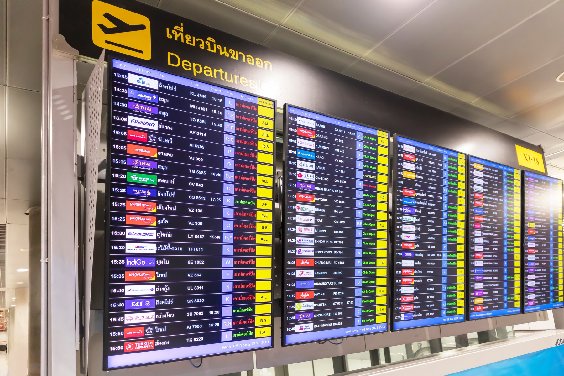 a colorful departure board at an airport.