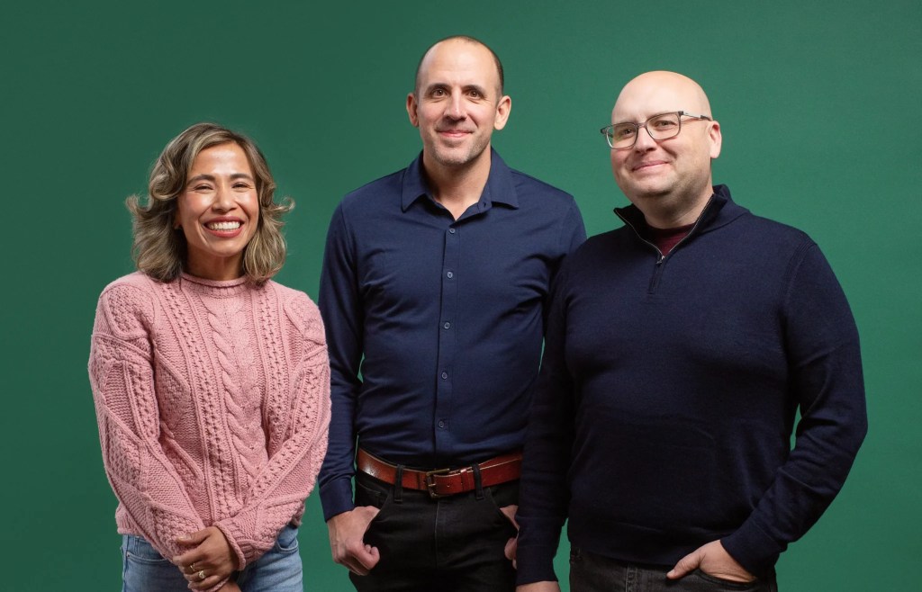 Two men and a woman posing for a photo.