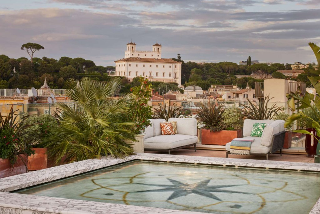 the swimming pool on the top of the Bulgari Hotel in Rome Italy shows the skyline of the city