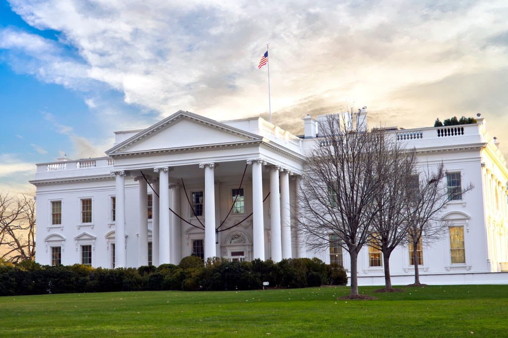 View of a Georgian-styled pillared white two-storey building.