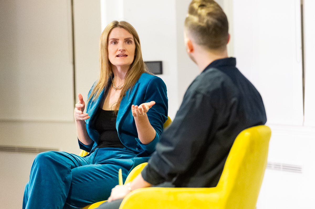 a woman speaks to a reporter onstage at an event Hannah Bennett, Head of Travel at TikTok, on-stage at Skift’s Megatrends event in London