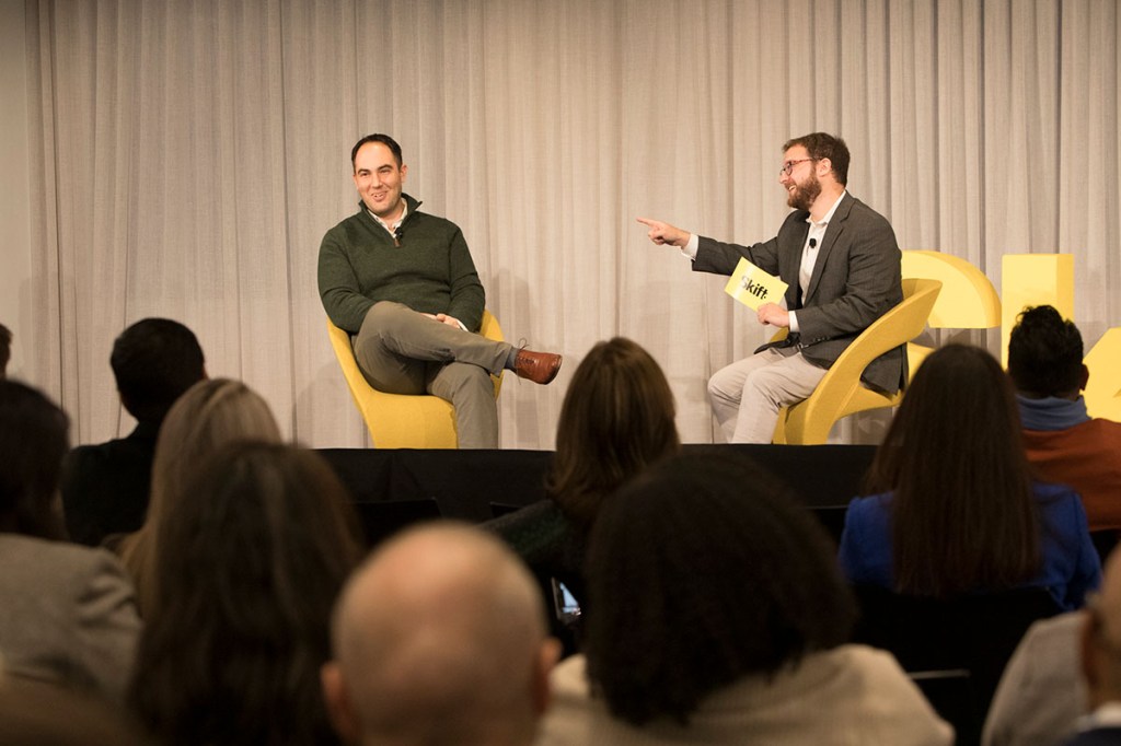 two men in a conversation on stage.